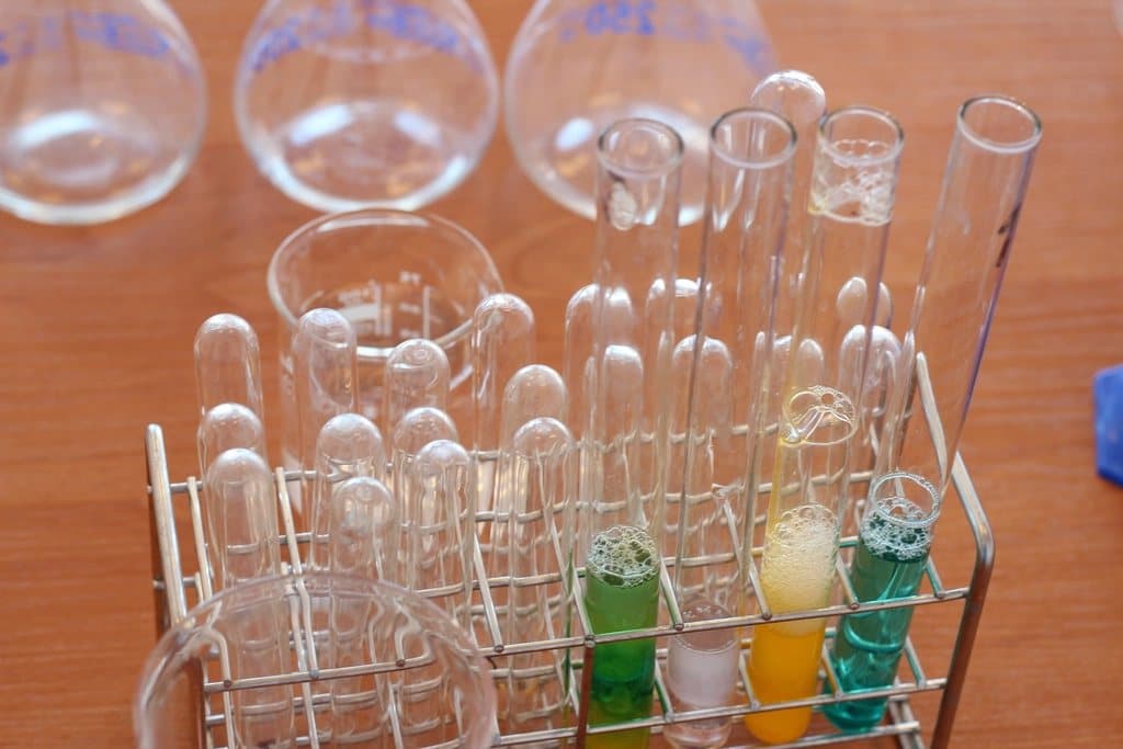 Laboratory glassware and test tubes arranged on a bench