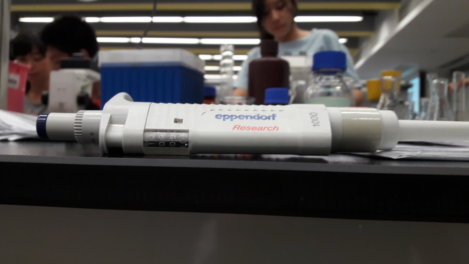 An Eppendorf Research single-channel air-displacement pipette on a laboratory bench